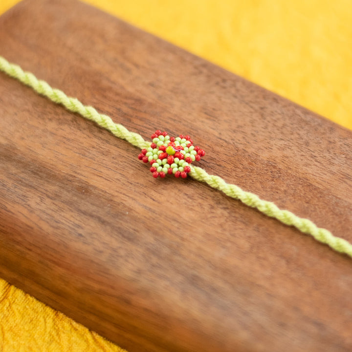 Sitara Collection Glass Beeds Rakhi Red Orange - Close-up of Beaded Centerpiece