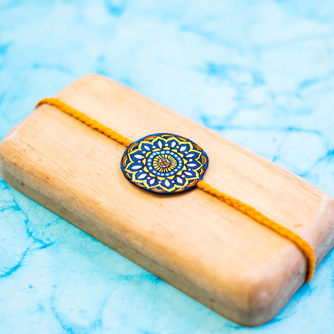 Hand-painted Eco-friendly Seed Rakhi with Roli Chawal - Orange