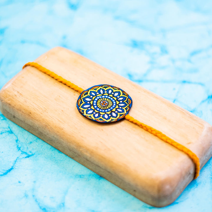 Hand-painted Eco-friendly Seed Rakhi with Roli Chawal - Orange