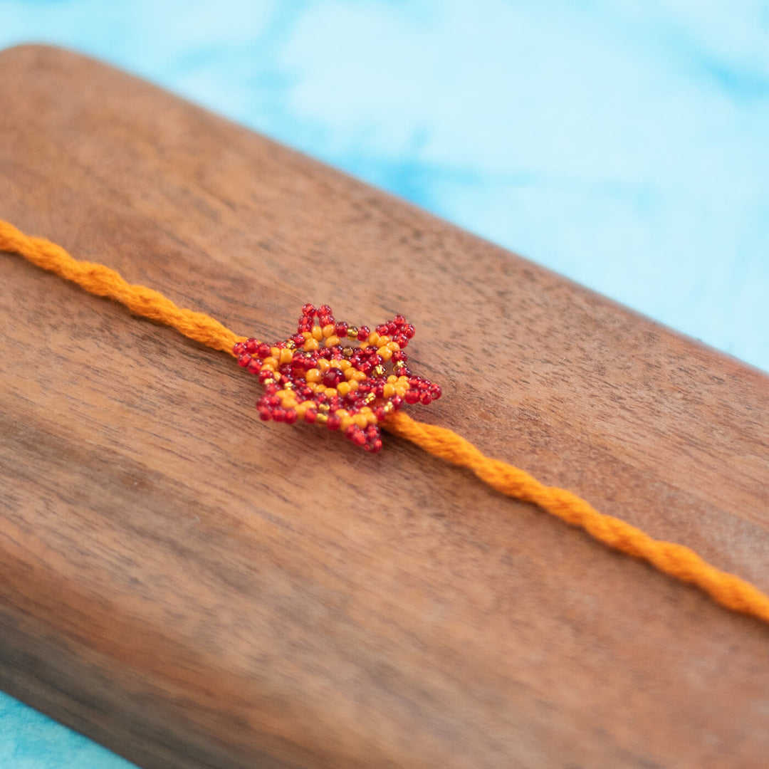 Sitara Collection Glass Beeds Rakhi Orange Red - Close-up of Beaded Centerpiece