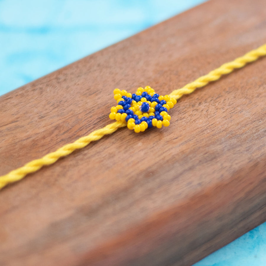 Sitara Collection Glass Beeds Rakhi Yellow Blue - Close-up of Bead Work Detail