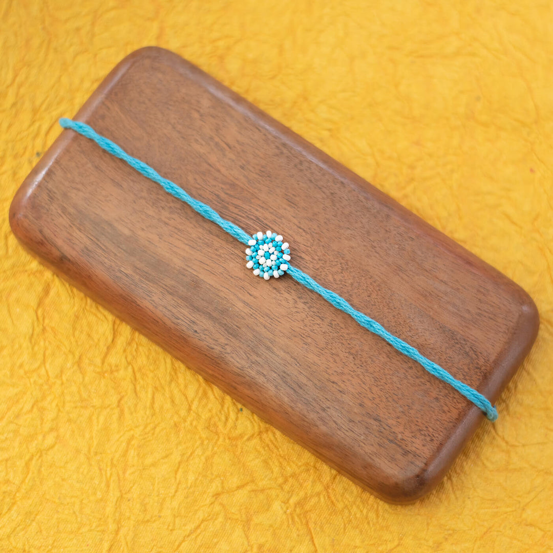 Chaand Collection Glass Beeds Rakhi Sky Blue - Flat Lay View on Wooden Board