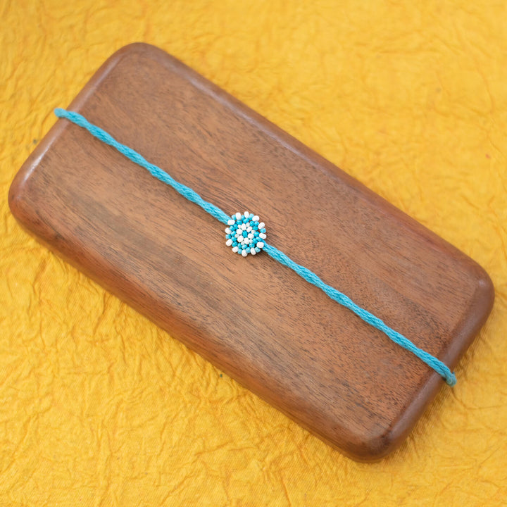 Chaand Collection Glass Beeds Rakhi Sky Blue - Flat Lay View on Wooden Board