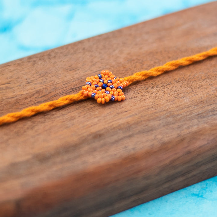 Phool Collection Glass Beeds Rakhi Orange Blue - Close-up of beadwork detail
