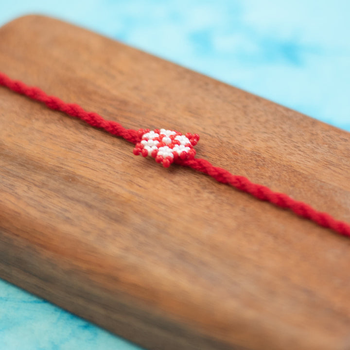 Phool Collection Glass Beeds Rakhi Red White - Close-up of Beaded Centerpiece