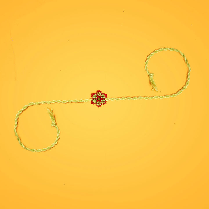 Sitara Collection Glass Beeds Rakhi Red Orange - Full Layout on Yellow Background