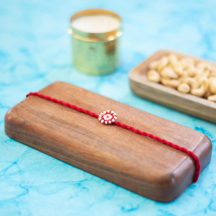 Chaand Collection Glass Beeds Rakhi Red - Front View with Background Props
