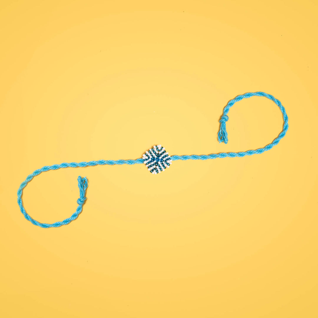 Raksha Collection Glass Beeds Rakhi Sky Blue - Full product on yellow background