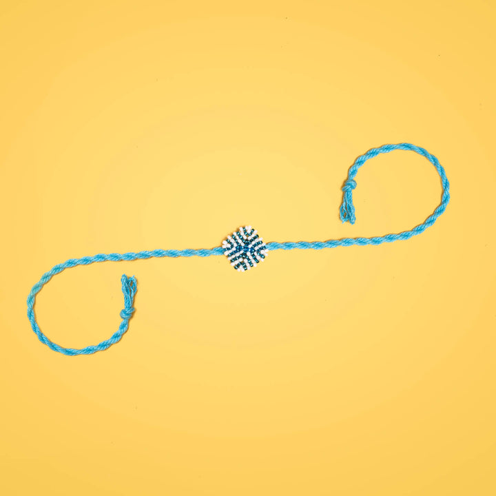 Raksha Collection Glass Beeds Rakhi Sky Blue - Full product on yellow background