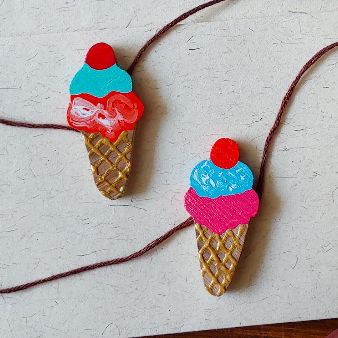 Handpainted Wooden Rakhi Set Of 2 Mini Birds - Close-up of ice cream designs
