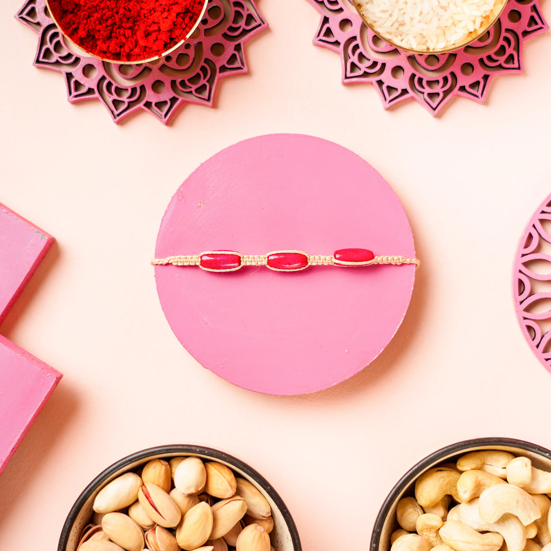 Pink Macrame Cotton Rakhi With Red Beads - Bracelet flat lay close-up