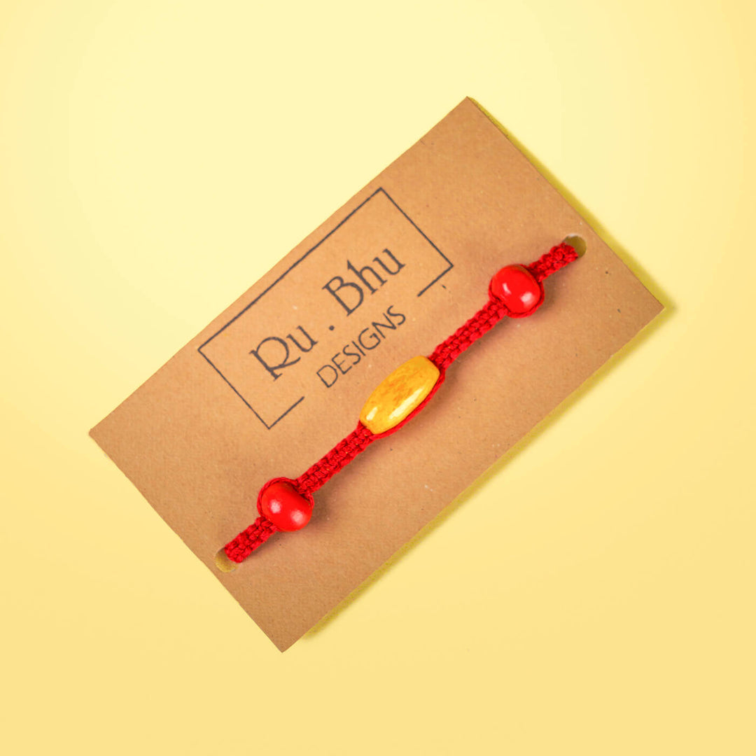 Red Macrame Cotton Rakhi With Red Yellow Beads - Bracelet on Brand Card