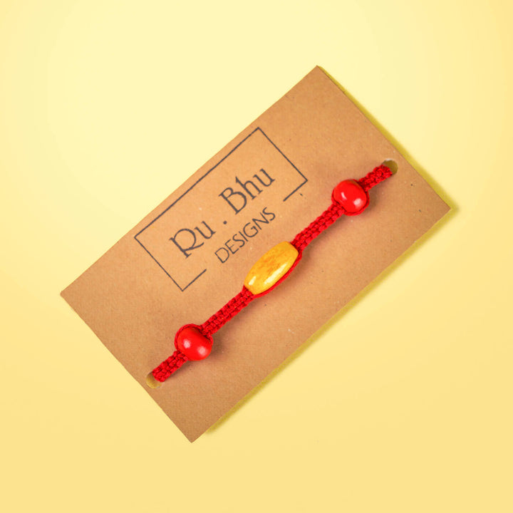 Red Macrame Cotton Rakhi With Red Yellow Beads - Bracelet on Brand Card