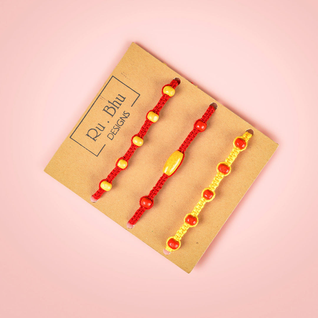 Red Yellow Rakhi With Beads Set Of 3 - Bracelets on branded packaging card