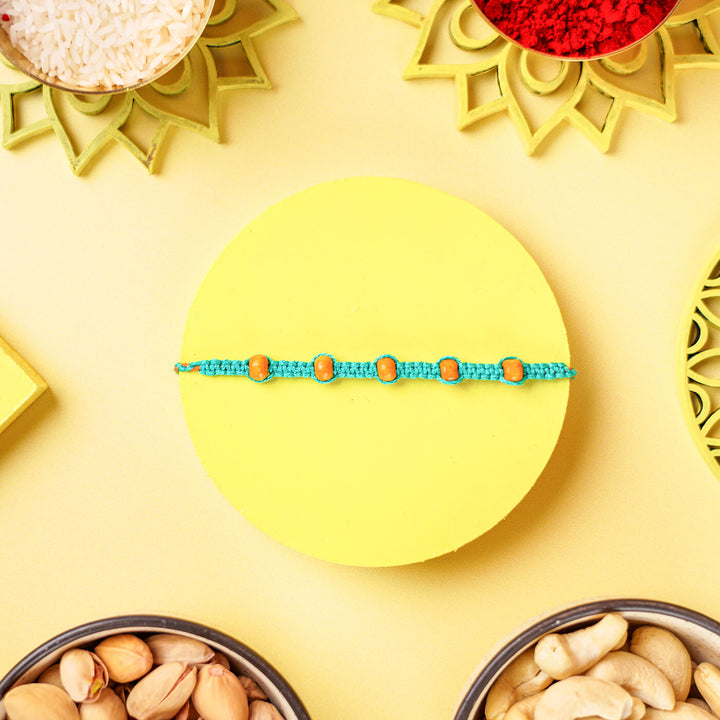 Teal Macrame Cotton Rakhi With Orange Beads - Bracelet front view flat lay