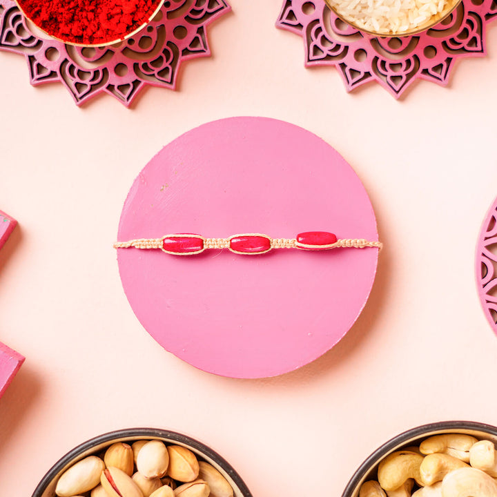 White Macrame Cotton Rakhi With Pink Beads - Flat Lay Close-up