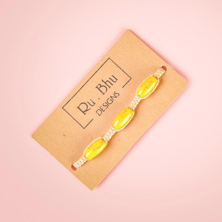 White Macrame Cotton Rakhi With Yellow Beads - Bracelet on branded card