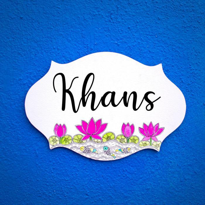 Madhubani Lotus Design Oval Cut Name Plate - Mounted on Blue Wall Background